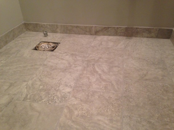 Powder Room floor with finished floor and grout. Florida Tile in Silverscreen and light grey grout