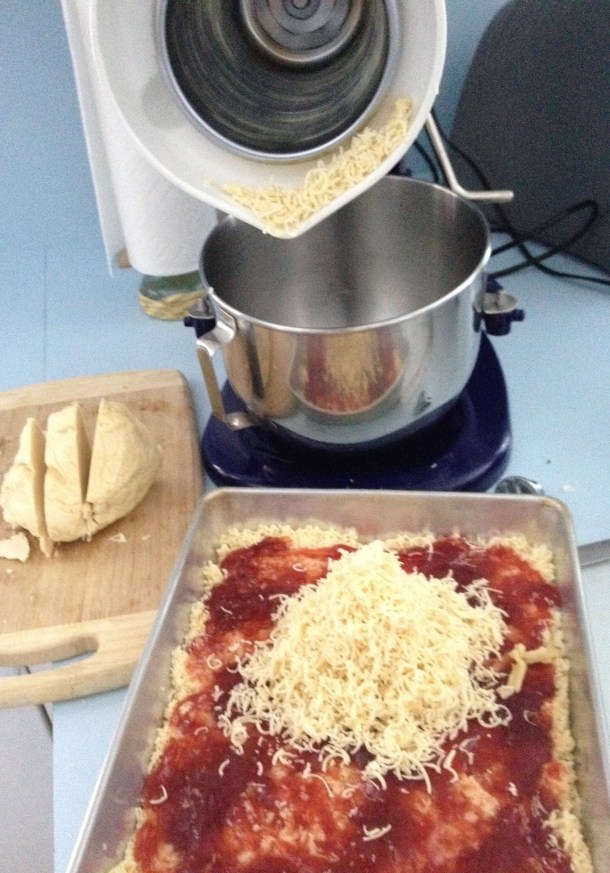 Grating the Dough Over the Strawberry Preserves